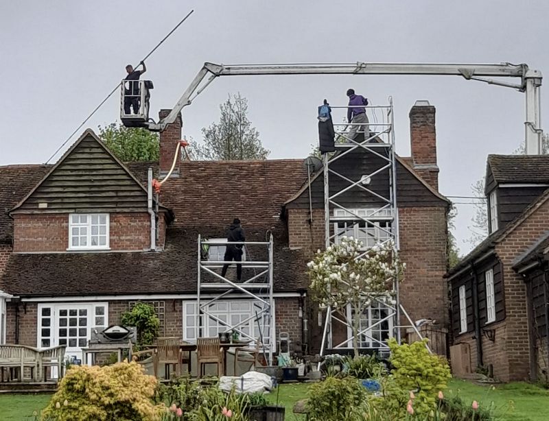 The Roof Moss Cleaners using cherry picker and scaffolding to clean roof safely and professionally in Hitchin, Hertfordshire